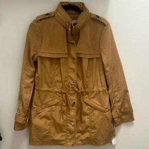 Tag on, tan fall/spring jacket with black accent buttons and silver zippers.